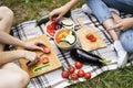 Unrecognizable teenagers camping and cooking. Royalty Free Stock Photo