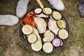 Unrecognizable teenagers cooking vegetables on barbecue grill. Royalty Free Stock Photo