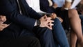 Group of unrecognizable unemployed businesspeople sitting in row on chairs Royalty Free Stock Photo