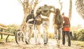 Group of urban friends walking in city skate park with backlighting at sunset - Youth and friendship concept with multiracial you