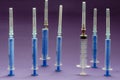 Group of used syringes on a lilac background
