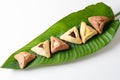 Jewish Hamantaschen homemade biscuits or cookies on palm leaf white background.