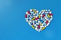 Various medicine pills arranged in heart shape