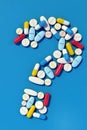 Various medicine pills arranged in question mark