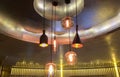 Group of Various Modern Style Black Metal and Glass Illuminated Lamps Hanging on The Ceiling Royalty Free Stock Photo