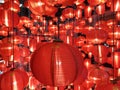 Group of various sizes vivid red round Chinese style lanterns hangs in beautiful random order with tiny sparkling starlight stripe