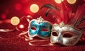 A group of Venetian or Mardi Gras masks on a dark, glittery surface with a bokeh light effect in the background. Royalty Free Stock Photo