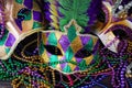 A group of Venetian and New Orlean Mardi gras mask with colorful beads on dark background Royalty Free Stock Photo