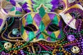 A group of Venetian and New Orlean Mardi gras mask with colorful beads on dark background Royalty Free Stock Photo