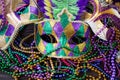 A group of Venetian and New Orlean Mardi gras mask with colorful beads on dark background Royalty Free Stock Photo