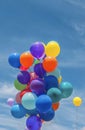 Group of vibrant and colorful balloons aloft in mid air Royalty Free Stock Photo