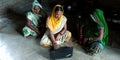 Group of village women learning computer operating system at home