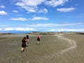 A group of visitors exploring low tide and the ocean vistas of Kanaka Bay, on Newcastle Island, across from Nanaimo