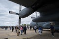 Group of visitors walking around a Lockheed C-130 Hercules aircraft at an air show Royalty Free Stock Photo