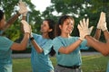 Group of volunteers celebrating success cleanup event in public park. Community and charity support concept Royalty Free Stock Photo