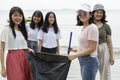 Group of asian volunteers cleaning sea beach