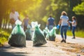 Group of volunteers collecting garbage in public park. Recycling concept