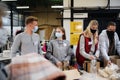 Group of volunteers in community charity donation center, food bank and coronavirus concept. Royalty Free Stock Photo