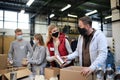 Group of volunteers in community charity donation center, food bank and coronavirus concept. Royalty Free Stock Photo