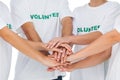 Group of volunteers putting hands together