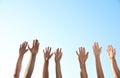 Group of volunteers raising hands outdoors