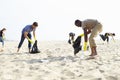 Group Of Volunteers Tidying Up Rubbish On Beach Royalty Free Stock Photo