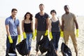 Group Of Volunteers Tidying Up Rubbish On Beach Royalty Free Stock Photo