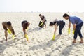 Group Of Volunteers Tidying Up Rubbish On Beach Royalty Free Stock Photo