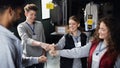 Group of volunteers at work in community charity donation center, fist bump.