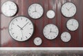 Group of wall clocks in a wooden wall .3d rendering