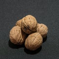 A group of walnuts on a black tablecloth Royalty Free Stock Photo