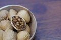 Group of walnut in wooden bowl on wood background, copy space, super food concept