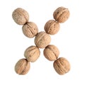 The group of walnuts on white background, making letter X. Studio shot Royalty Free Stock Photo