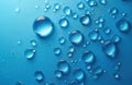 Group of water droplets on blue surface. Transparent hydrating fluid with clear surface, moisture and condensation. Purity and Royalty Free Stock Photo
