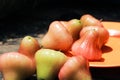 A group water guava that is picked on its own tree and photographed on a wooden table at home, not fancy