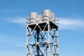 Group of Water tower rising from trees against blue sky,Constructed at a height sufficient to pressurize a water supply system