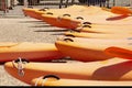 group of waterproof dinghy kayaks lined up in the color of the year apricot crush. Sports boats on the coast close-up