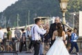 A group of wedding photographers on the streets of Budapest is holding a photo session for a couple of newlyweds. Royalty Free Stock Photo