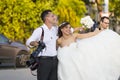 A group of wedding photographers on the streets of Budapest is holding a photo session for a couple of newlyweds. Royalty Free Stock Photo