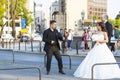A group of wedding photographers on the streets of Budapest is holding a photo session for a couple of newlyweds. Royalty Free Stock Photo