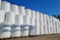 Group of white big bags with chemical fertilizers in a warehouse outdoors