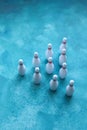 Group of white bowling pins on a blue background. Selective focus. Royalty Free Stock Photo