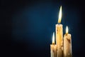 Group of white candles burning in the dark Royalty Free Stock Photo