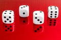 Closeup of a group of white dice on a red reflective surface Royalty Free Stock Photo