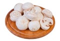 Group of white field mushroom on wood plate