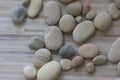 Group of white, grey and light brown stones on white light wooden background, pebbles beach Royalty Free Stock Photo