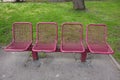 Group of red metal modern chairs in the park. Royalty Free Stock Photo