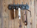 Group of white old ice skates hanging on a wooden wall Royalty Free Stock Photo