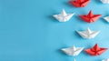 Group of white paper ships sailing together, contrasted by one red ship pointing a different way on a blue background. Ai Royalty Free Stock Photo