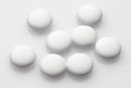 Group of white pills on white background - healthcare and medicament concept. Pharmaceutical industry. Pharmacy